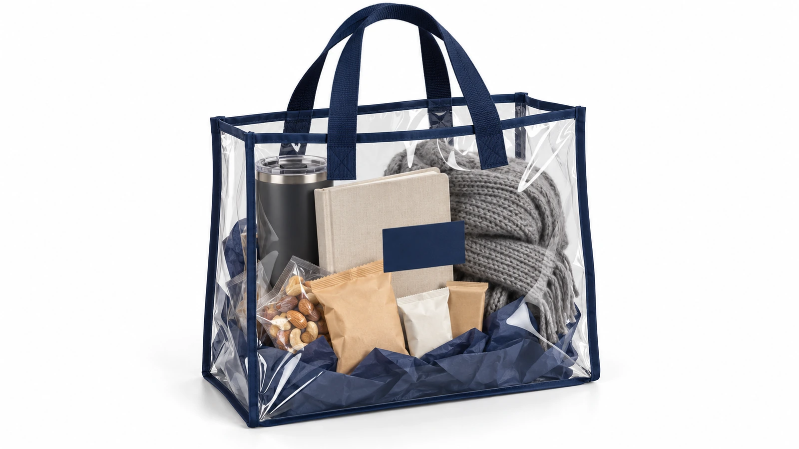 Túi tote PVC trong suốt viền xanh navy đựng bộ quà doanh nghiệp được chọn lọc gồm ly giữ nhiệt, sổ tay, đồ ăn vặt và một chiếc khăn gấp, tất cả đều nhìn thấy qua túi